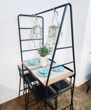 Stylish compact dining nook with a wood tableto...
