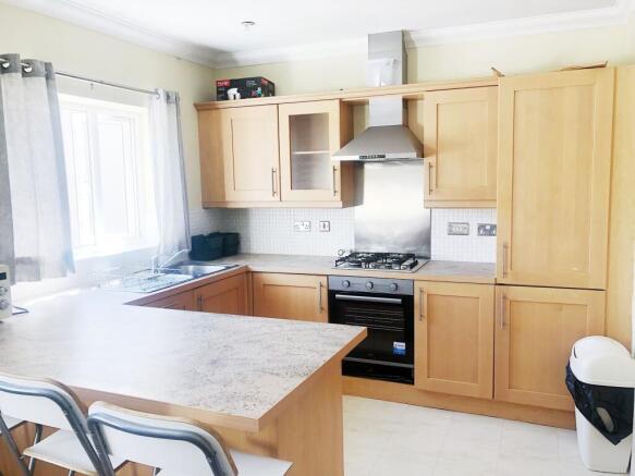 Bright modern kitchen with light wood cabinetry...