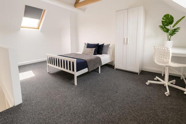 Bright and minimalist single bedroom featuring ...