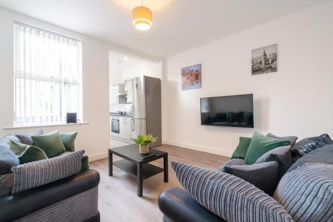 Bright and welcoming living room featuring comf...