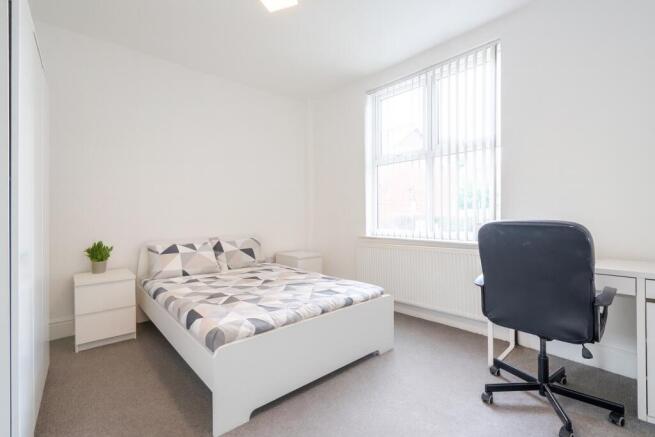 Bright and well-maintained bedroom featuring a ...