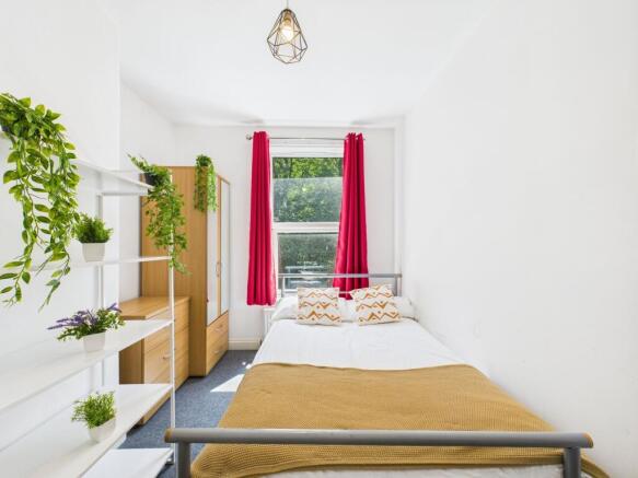 Bright and inviting bedroom featuring a double ...