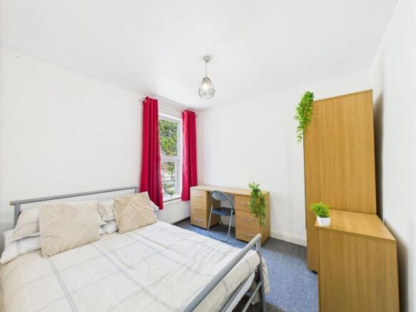 Bright and welcoming master bedroom featuring a...