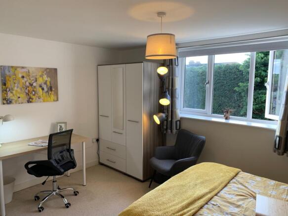 A bright and inviting double bedroom featuring ...