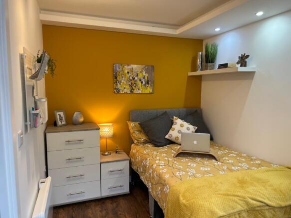 A bright and inviting double bedroom with styli...