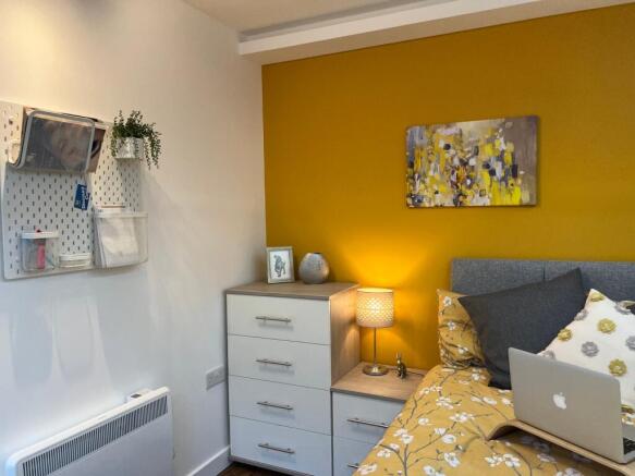 A bright and inviting double bedroom with moder...