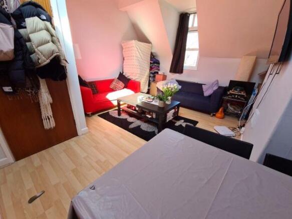 A cozy living room featuring a red sofa, coffee...