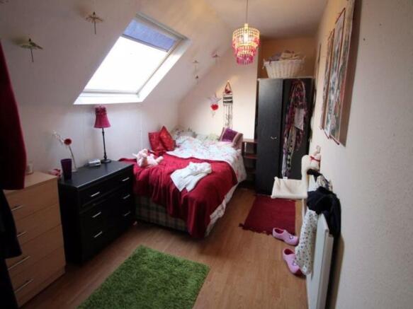 A bright and inviting master bedroom featuring ...