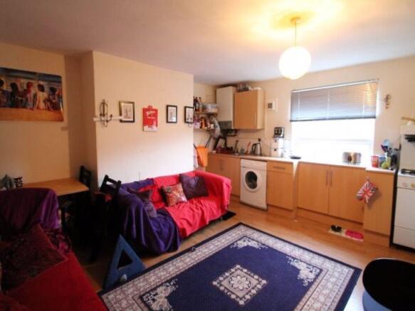 A spacious and well-lit living room featuring c...