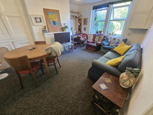 A spacious and inviting living room filled with...