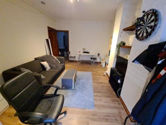 Spacious and inviting living room featuring com...