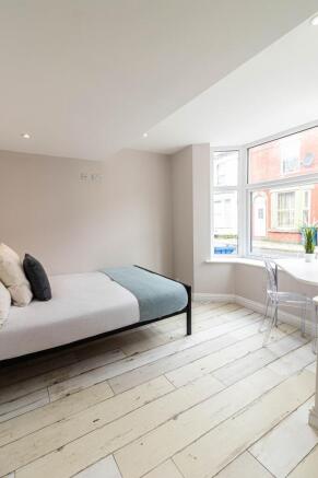 Bright and modern bedroom featuring a single be...