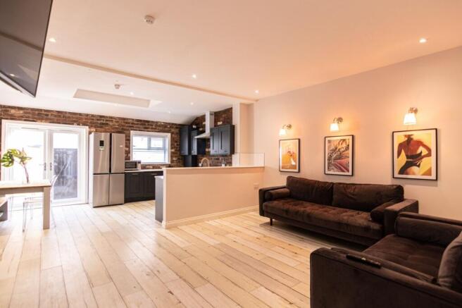 Bright, modern open-plan living area with expos...