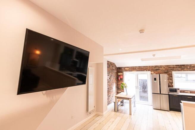 Bright open-plan living area with a wall-mounte...