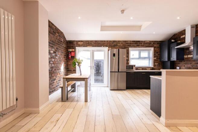 Bright open-plan kitchen and dining area with e...