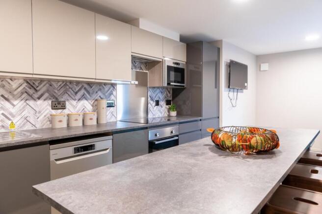 Modern and sleek kitchen featuring a spacious c...