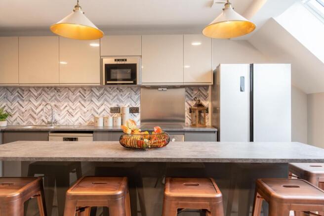 Modern and well-maintained kitchen featuring sl...