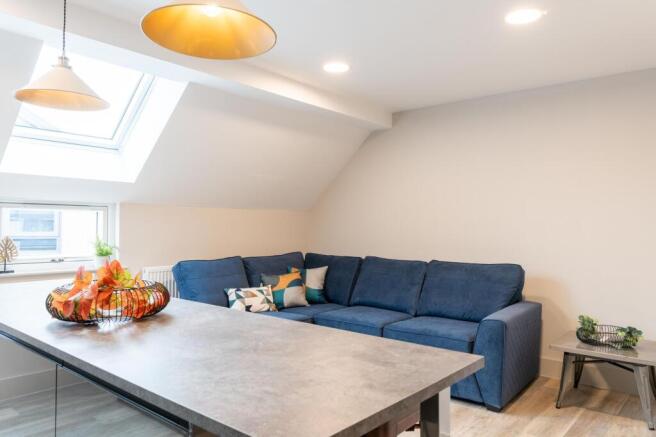 A spacious and modern living room featuring a l...