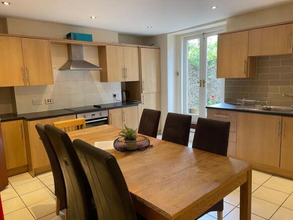 Bright modern kitchen with wooden cabinets, dar...