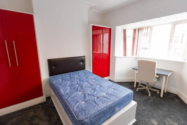 Bright bedroom with a comfortable double bed, b...