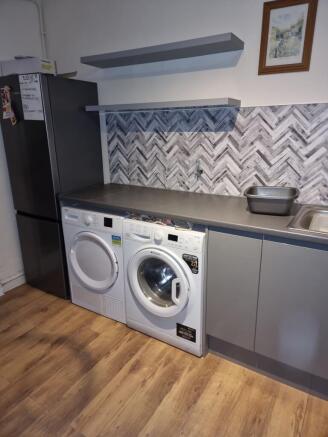 Modern utility-style kitchen area with integrat...