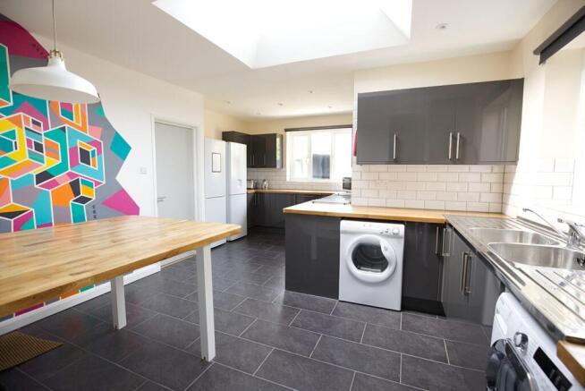 Bright and modern kitchen featuring sleek dark ...