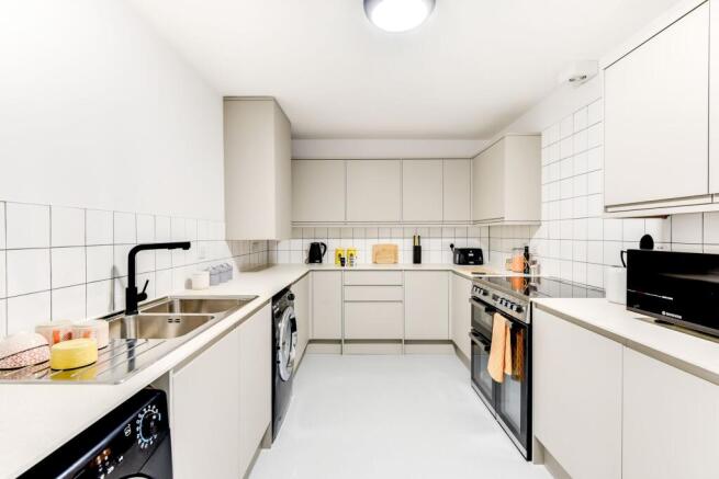 Modern kitchen featuring sleek cabinetry, ample...