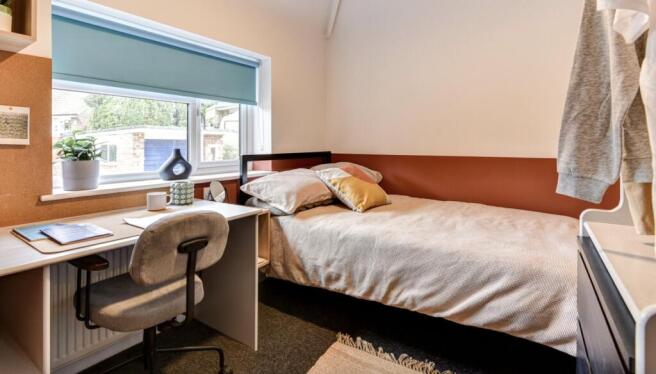 This inviting double bedroom features a cozy la...