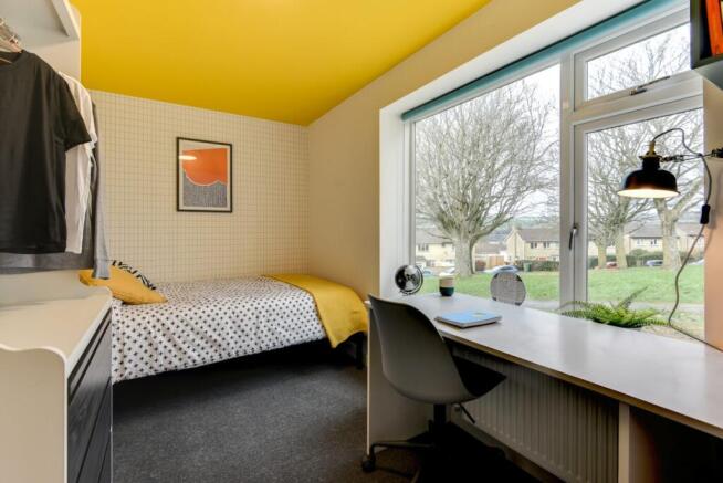 Bright, modern bedroom with a cosy single bed d...