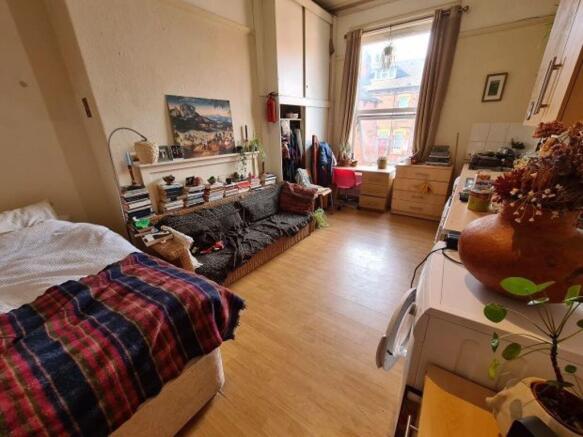 Bright and cozy bedroom featuring a large windo...