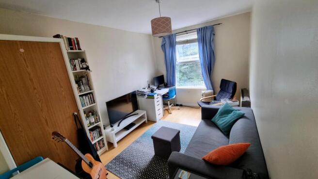 A cozy and well-maintained living room featurin...