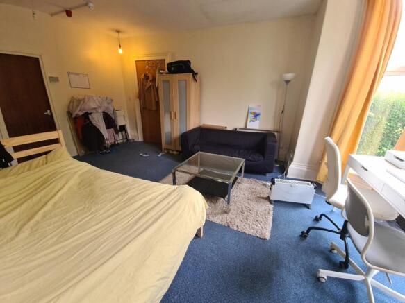 A spacious and bright master bedroom featuring ...