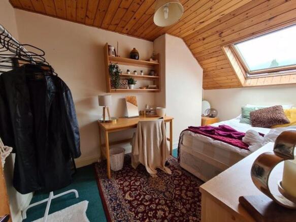 Bright and cozy master bedroom featuring a slop...