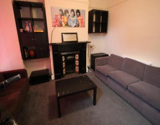 A cozy living room featuring a comfortable sofa...