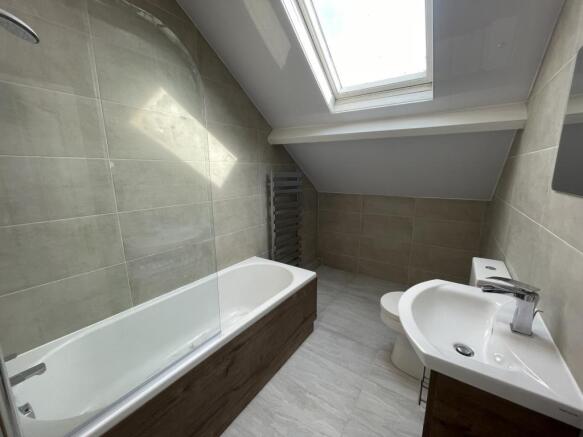 Bright modern bathroom with a fitted bathtub, c...