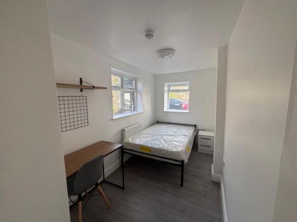 Bright and spacious double bedroom featuring la...