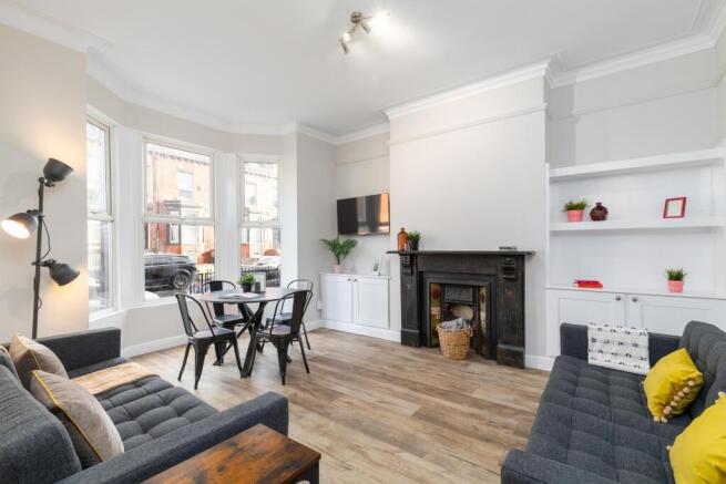 Bright, stylish living room with a bay window, ...