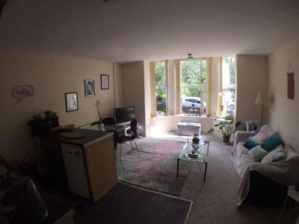 Bright, inviting living room with large front w...