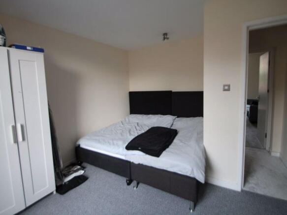 Bright, neutrally decorated double bedroom with...