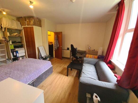 Bright, well-kept bedroom with a double bed, so...