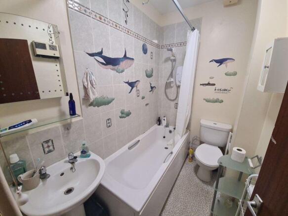 Bright, well-kept bathroom with a bathtub and s...