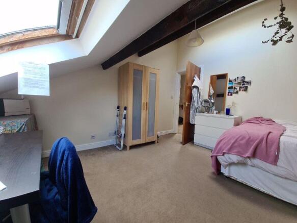Bright double bedroom with a sloped skylight, e...
