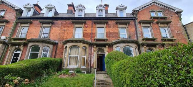 Attractive red-brick terraced house frontage wi...