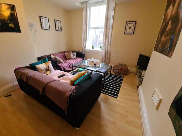 Bright, comfortable living room with a large L-...