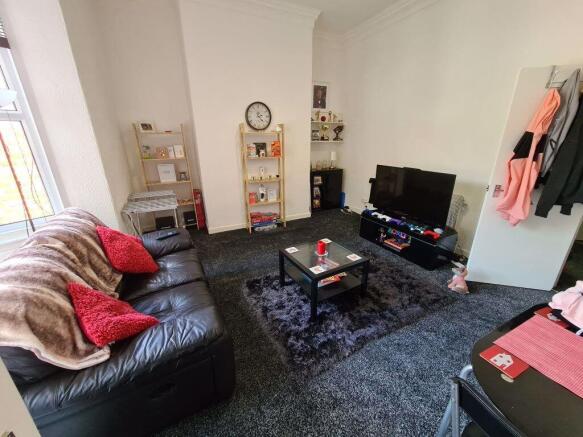 Bright, well-kept communal living room with a l...