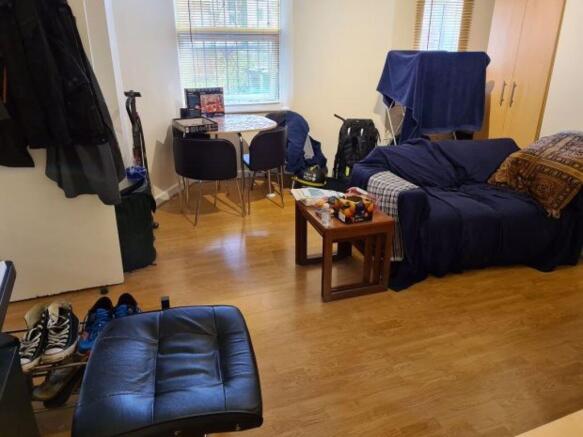 Bright, well-kept living area with wooden floor...