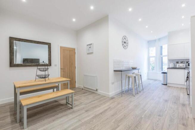 Bright, modern open-plan living area with conte...