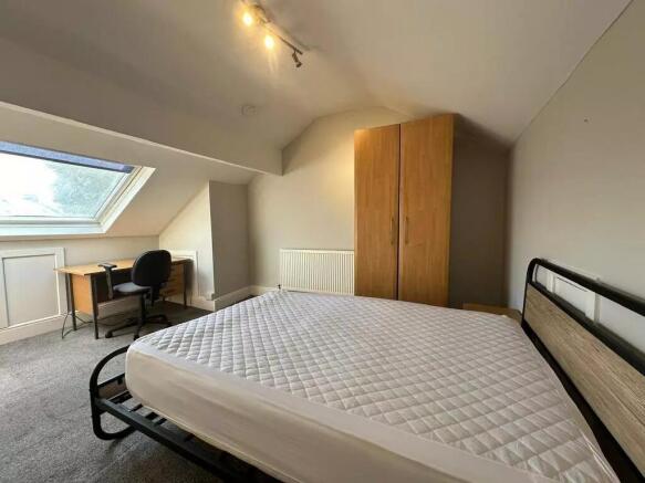 Bright and spacious master bedroom featuring a ...