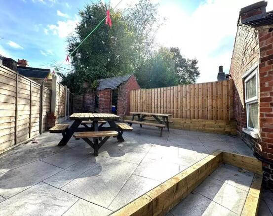 A bright and spacious outdoor garden area featu...