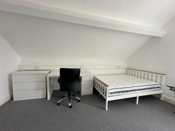 Bright and tidy double bedroom featuring a whit...